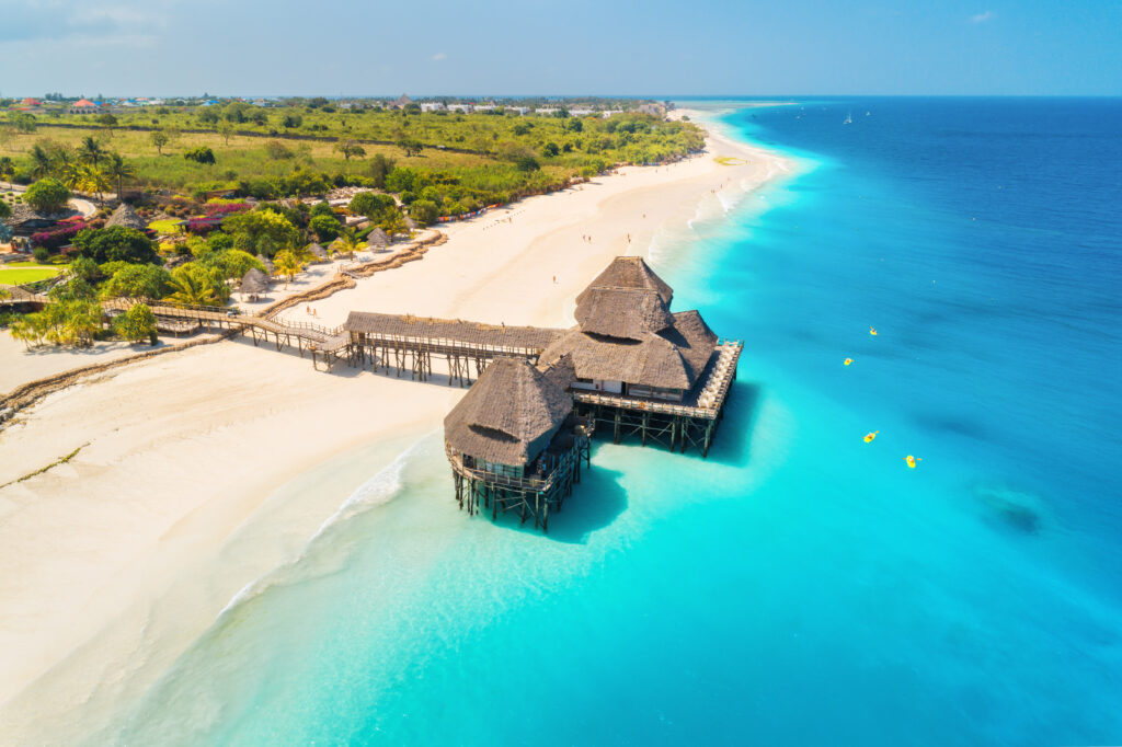 Luchtfoto van een luxe hotel op het water omringd door kristalhelder water, geschikt voor halal vakanties.